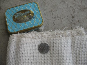 Cotton monks' cloth (quarter for scale) and smaller cooking tin
